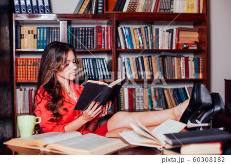 girl reading a book on the table legs girl reading a book on the table legs 60308182