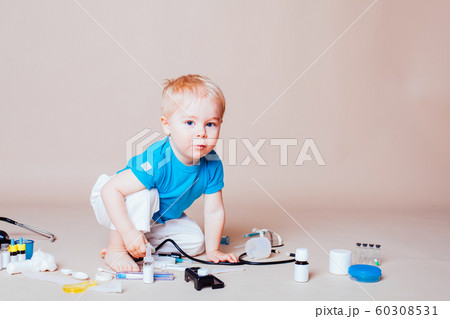 a boy plays in doctor medicine hospital a boy plays in doctor medicine hospital 60308531