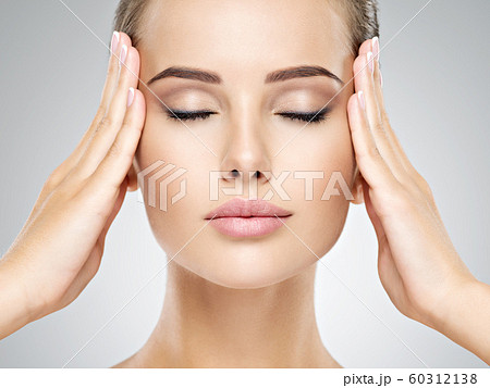 Beautiful face of young woman with perfect health 60312138
