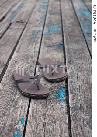 brown flip flops slippers on old wooden deck 60316378
