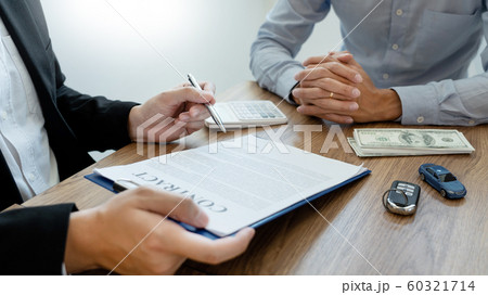 agent broker man holding document showing an 60321714