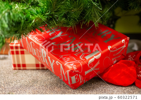 Christmas gifts laying underneath of fir tree branches. Christmas gifts laying underneath of fir tree branches. 60322571