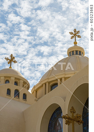 Coptic Orthodox Church in Sharm El Sheikh, Egypt.Against the backdrop of a beautiful sky with clouds. All Saints Church. Concept of the righteous faith. vertical photo Coptic Orthodox Church in Sharm El Sheikh, Egypt.Against the backdrop of a beautiful sky with clouds. All Saints Church. Concept of the righteous faith. vertical photo 60323663