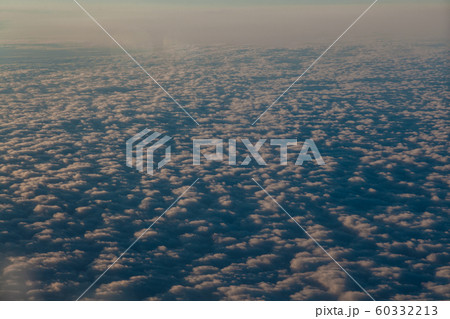 flying above the clouds at sunset landscape from an airplane flying above the clouds at sunset landscape from an airplane 60332213