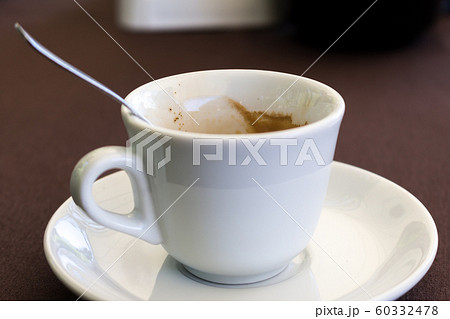 used cup of coffee and steel cuckoo 60332478