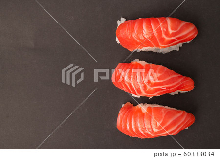 Salmon sushi on black background. Salmon sushi on black background. 60333034