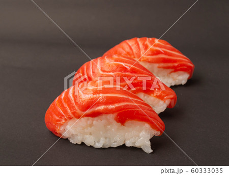 Salmon sushi on black background. 60333035