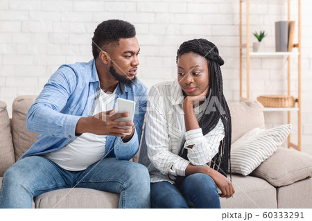 Jealous Boyfriend Showing His Cheating Girlfriend Her Phone, Demanding Explanation 60333291