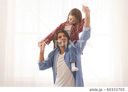 Cute little girl playing with her cheerful father 60333705