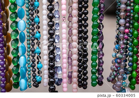 Various colorful beads in the market. Wallpaper background of a colorful necklace made of precious Various colorful beads in the market. Wallpaper background of a colorful necklace made of precious 60334005