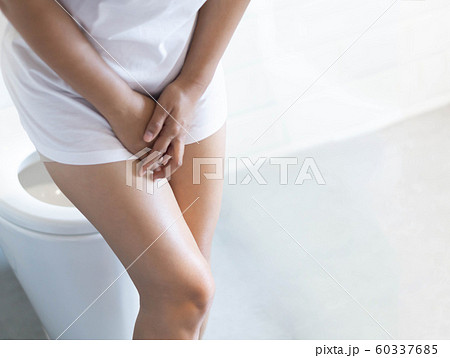 Close up woman stomachache with toilet  60337685
