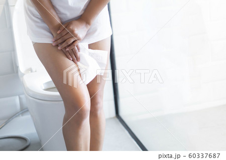Close up woman stomachache with toilet Close up woman stomachache with toilet 60337687