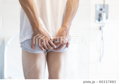 Closeup man holding bladder with pee pain 60337883