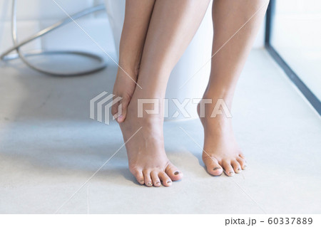 Closeup woman sitting on toilet in the morning 60337889