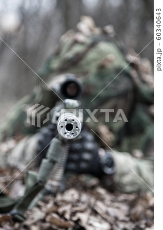 Sniper shooting from masked position on ground Sniper shooting from masked position on ground 60340643