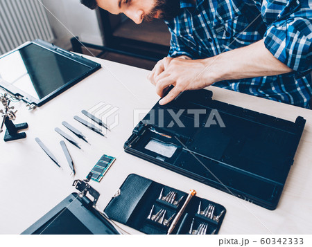 tech support engineer disassembling laptop tools tech support engineer disassembling laptop tools 60342333