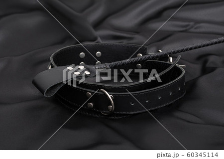 Stack for bdsm games and leather collar on black 60345114