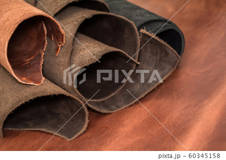 Rolls of natural brown and black leather. Rolls of natural brown and black leather. 60345158