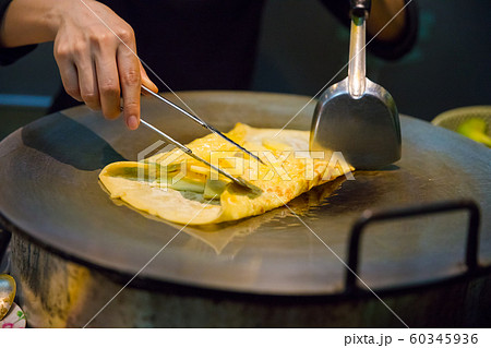 Person Preparing Pineapple Pancake At Market Stall Person Preparing Pineapple Pancake At Market Stall 60345936