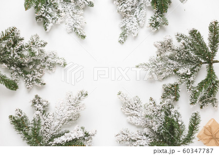 Christmas still life. Spruce branches form a frame with white copespace in the middle 60347787