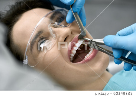 Pretty woman's teeth treatment in dental clinic 60349335