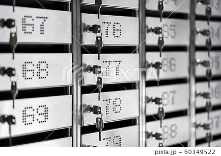 Numbered metal mailboxes with keys in them 60349522