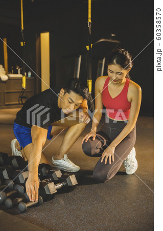 Male and female exercising in gym. Sport, fitness, weightlifting and training concept 007 Male and female exercising in gym. Sport, fitness, weightlifting and training concept 007 60358570
