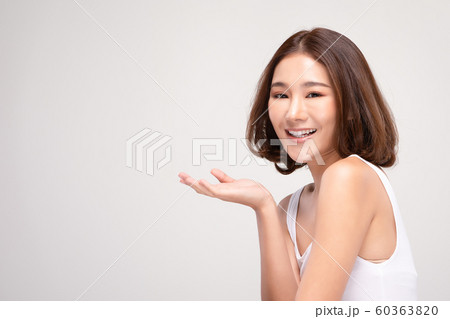 Beautiful Attractive Charming Asian young woman smile with white teeth open hand palm for display cosmetics product cheerful with healthy skin,isolated on white background,Beauty Cosmetics Concept 60363820