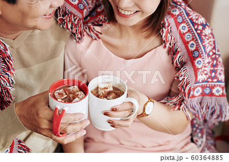 Couple drinking sweet cocoa Couple drinking sweet cocoa 60364885