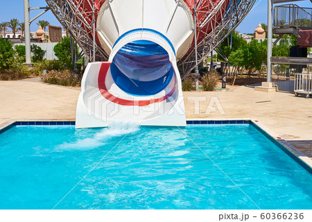 Colored water slide in water park with a swimming pool Colored water slide in water park with a swimming pool 60366236