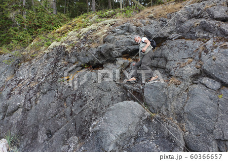 Man with a backpack going down a rock 60366657