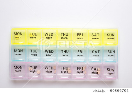 Organizer for medical pills on a white isolated background close-up. Organization of taking pills of the day. Organizer for medical pills on a white isolated background close-up. Organization of taking pills of the day. 60366702
