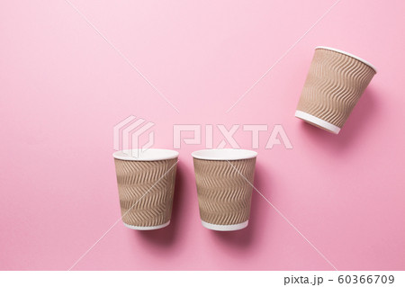 Paper cup for hot coffee or tea on a pink isolated background. 60366709