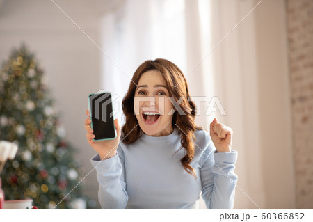 Beautiful young woman with long hair looking happy 60366852