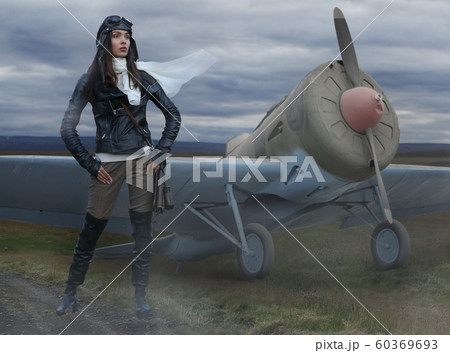 Beautiful girl pilot and retro airplane 60369693