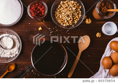 Melted chocolate in saucepan next to ingredients Melted chocolate in saucepan next to ingredients 60370654