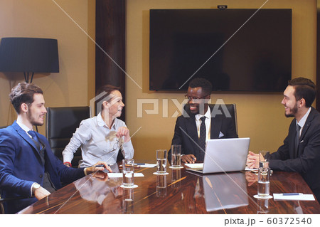 Corporate business team meeting in a modern open plan office. Corporate business team meeting in a modern open plan office. 60372540