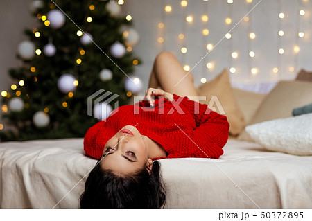 beautiful sexy woman in erotic black lace lingerie and red sweater 60372895