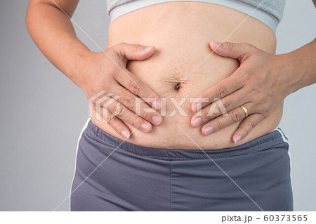 Close up of Woman touching belly skin with stretch Close up of Woman touching belly skin with stretch 60373565