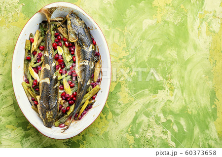 Baked fish with pomegranate 60373658