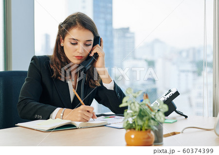Business lady talking on phone Business lady talking on phone 60374399