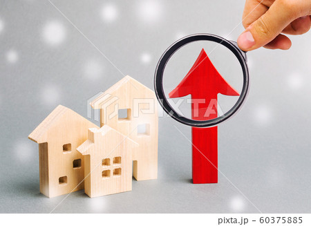 Miniature wooden houses and up arrow with snowflakes. The concept of high housing demand. Investments for real estate in the winter. Mortgage interest rates. Expensive cost. Christmas market Miniature wooden houses and up arrow with snowflakes. The concept of high housing demand. Investments for real estate in the winter. Mortgage interest rates. Expensive cost. Christmas market 60375885