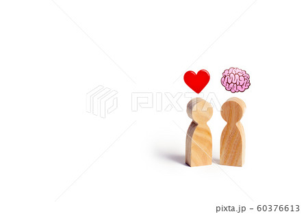 Two wooden figures with the image of the brain and heart. The balance between love and mind. Family versus career or work. Family psychology. Problem of choice. 60376613