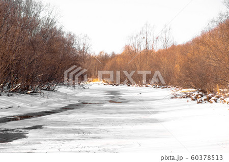 Frozen river in a Russian village. On ice and snow. 60378513