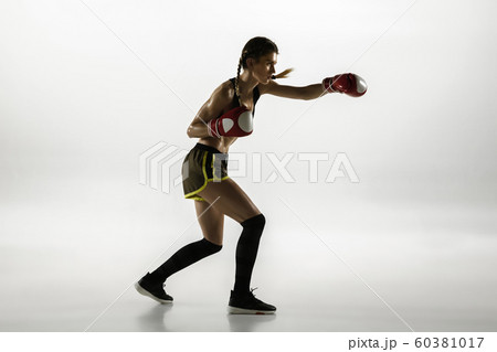 Fit caucasian woman in sportswear boxing isolated on white studio background Fit caucasian woman in sportswear boxing isolated on white studio background 60381017