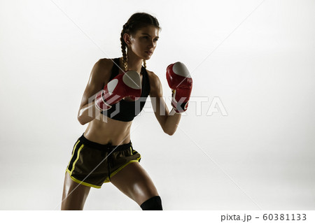 Fit caucasian woman in sportswear boxing isolated on white studio background 60381133