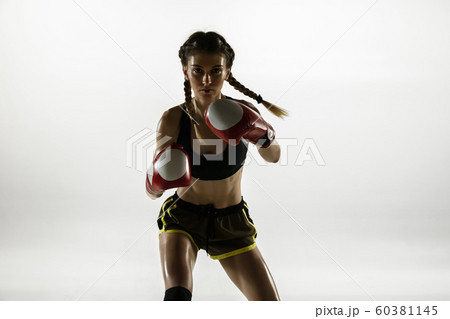 Fit caucasian woman in sportswear boxing isolated on white studio background Fit caucasian woman in sportswear boxing isolated on white studio background 60381145