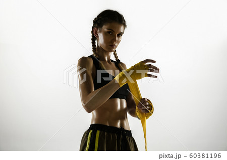Fit caucasian woman in sportswear boxing isolated on white studio background 60381196