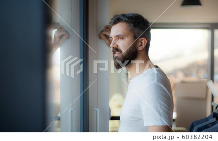 Mature man standing in house, moving in new home concept. 60382204