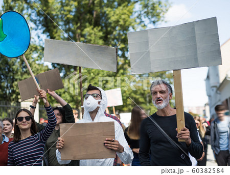 People with placards and protective suit on global strike for climate change. 60382584